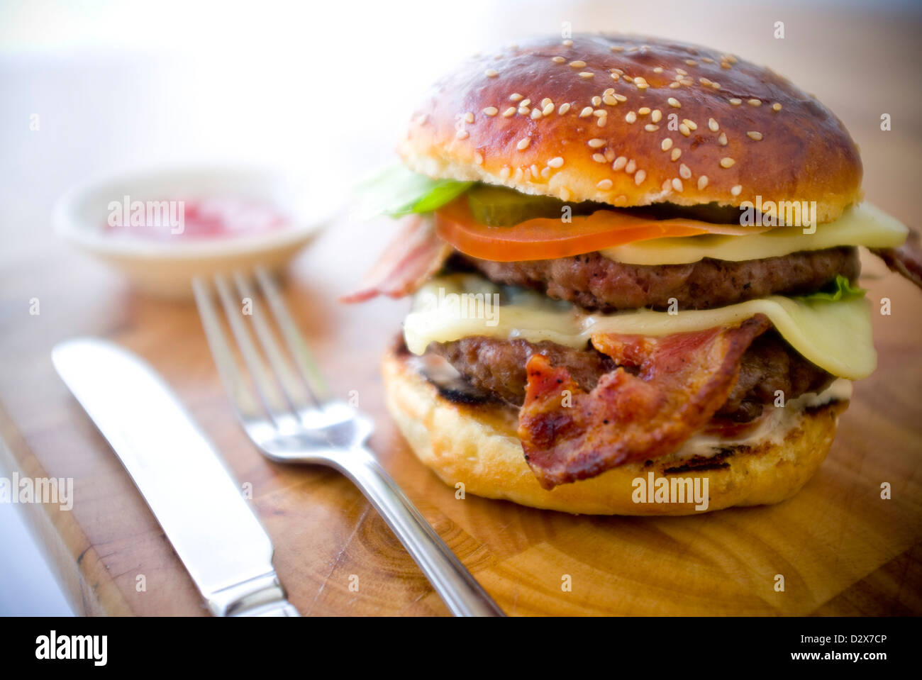 Double Cheese Two burgers, layered with cheese, bacon, tomato