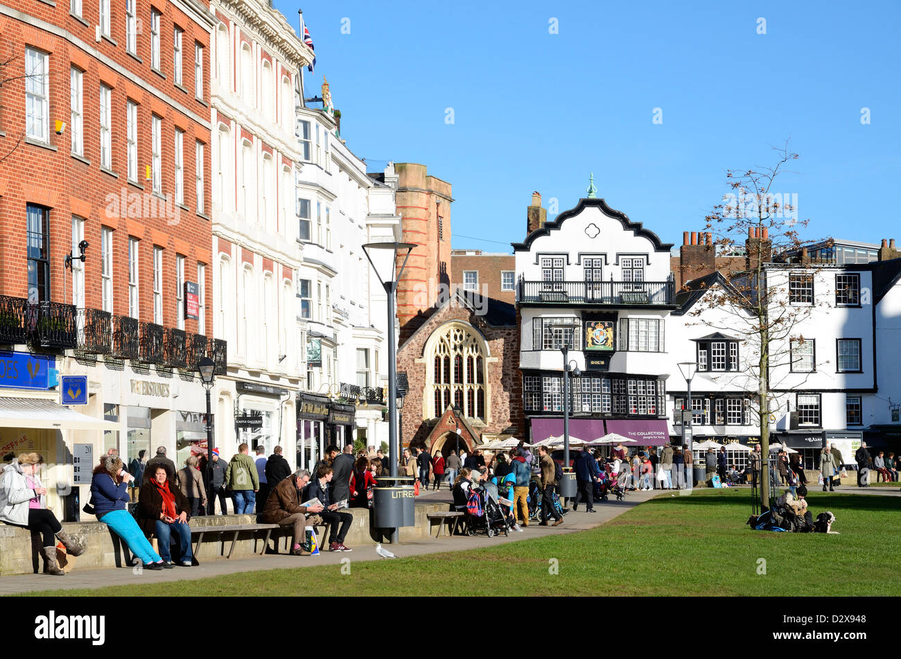 tourists enjoying the winter sunshine on cathedral square in exeter, devon, uk Stock Photo