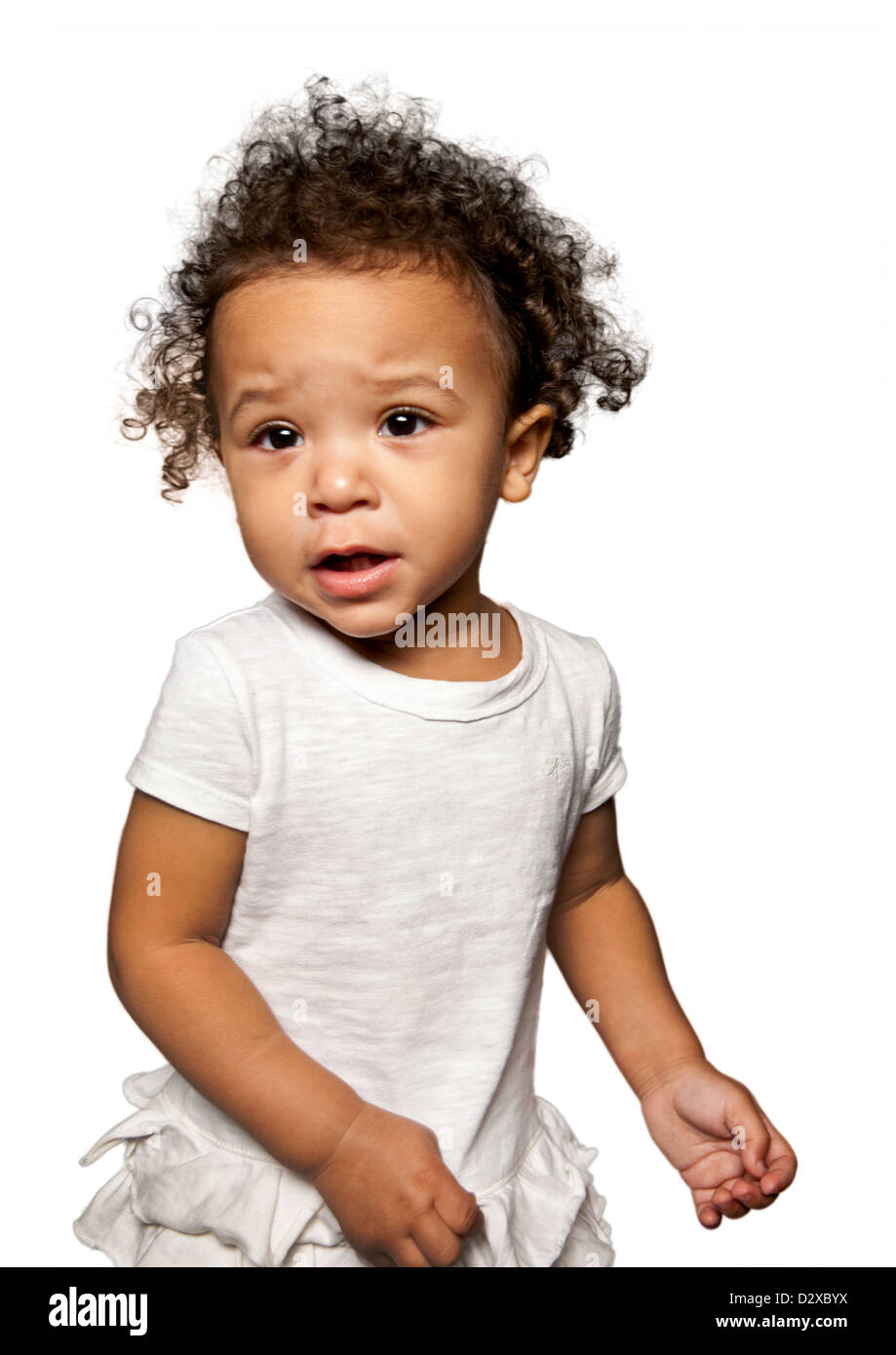 Studio portraits of mixed race toddler girl wearing a white vest