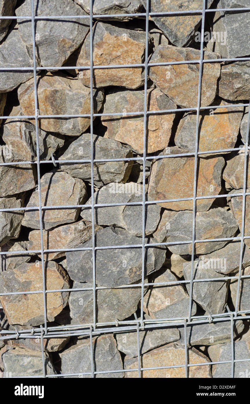 A retaining wall made from wire mesh and stone Stock Photo Alamy