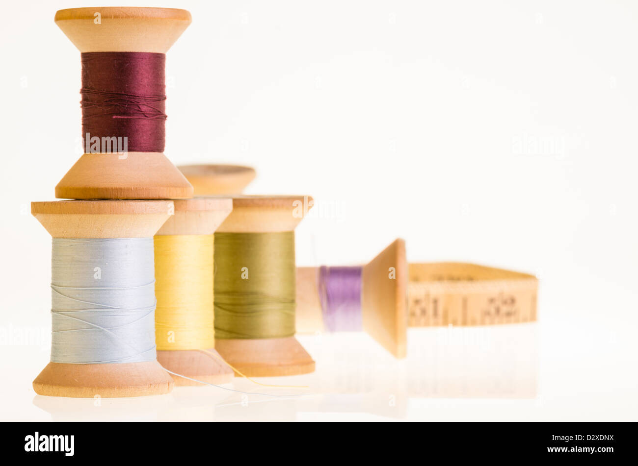 Spools of thread and a measuring tape on white Stock Photo - Alamy
