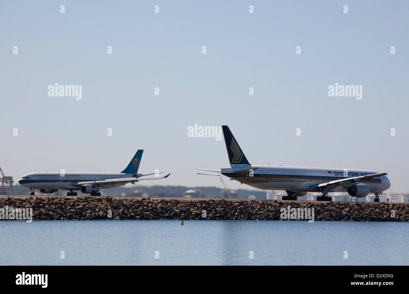 commercial passenger Jet Aircraft taxing past each other on the tarmac at Kingsford Smith Airport Sydney Australia Stock Photo