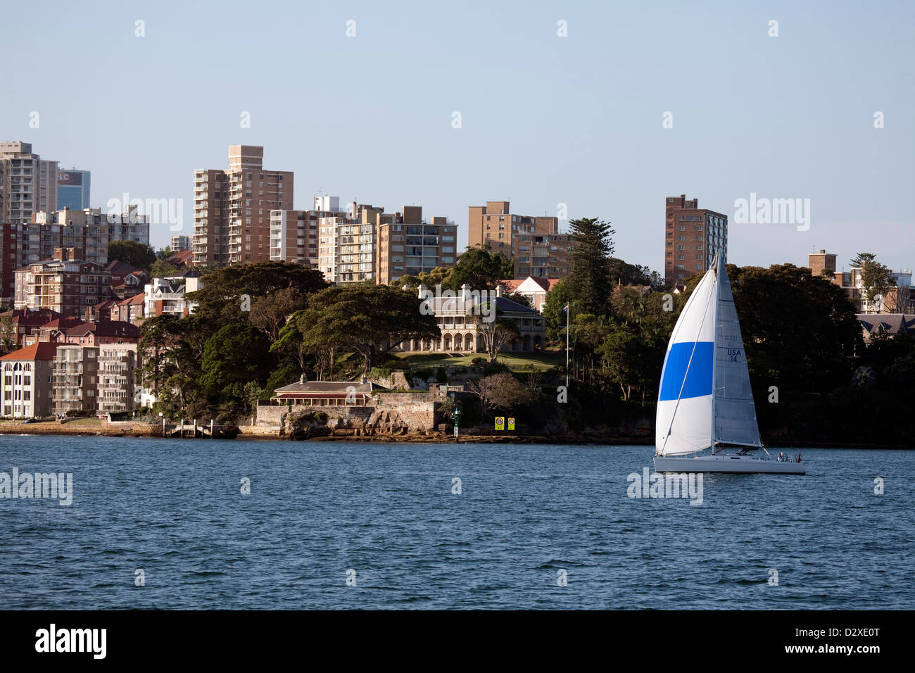 Yacht sailing in front of  high-rise residential apartments and Admiralty House Kirribilli Sydney Australia Stock Photo
