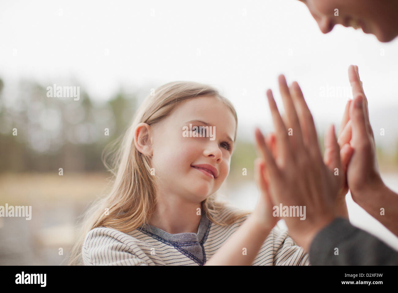 Close up of mother and daughter playing pat-a-cake Stock Photo