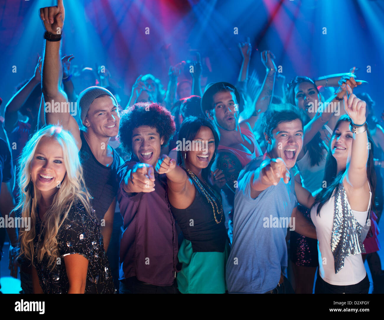 Portrait of enthusiastic crowd on dance floor of nightclub Stock Photo