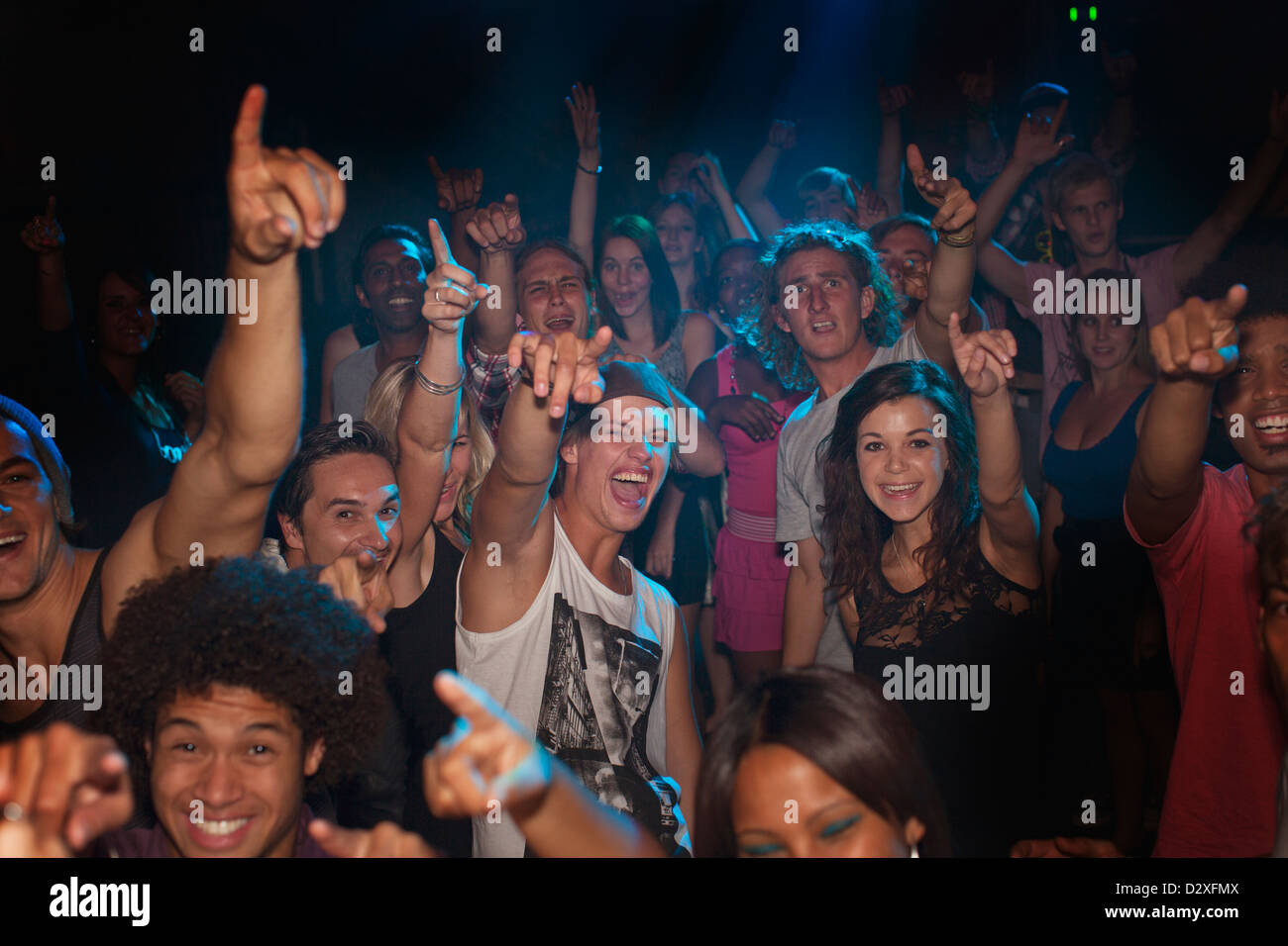 Enthusiastic crowd cheering at concert Stock Photo