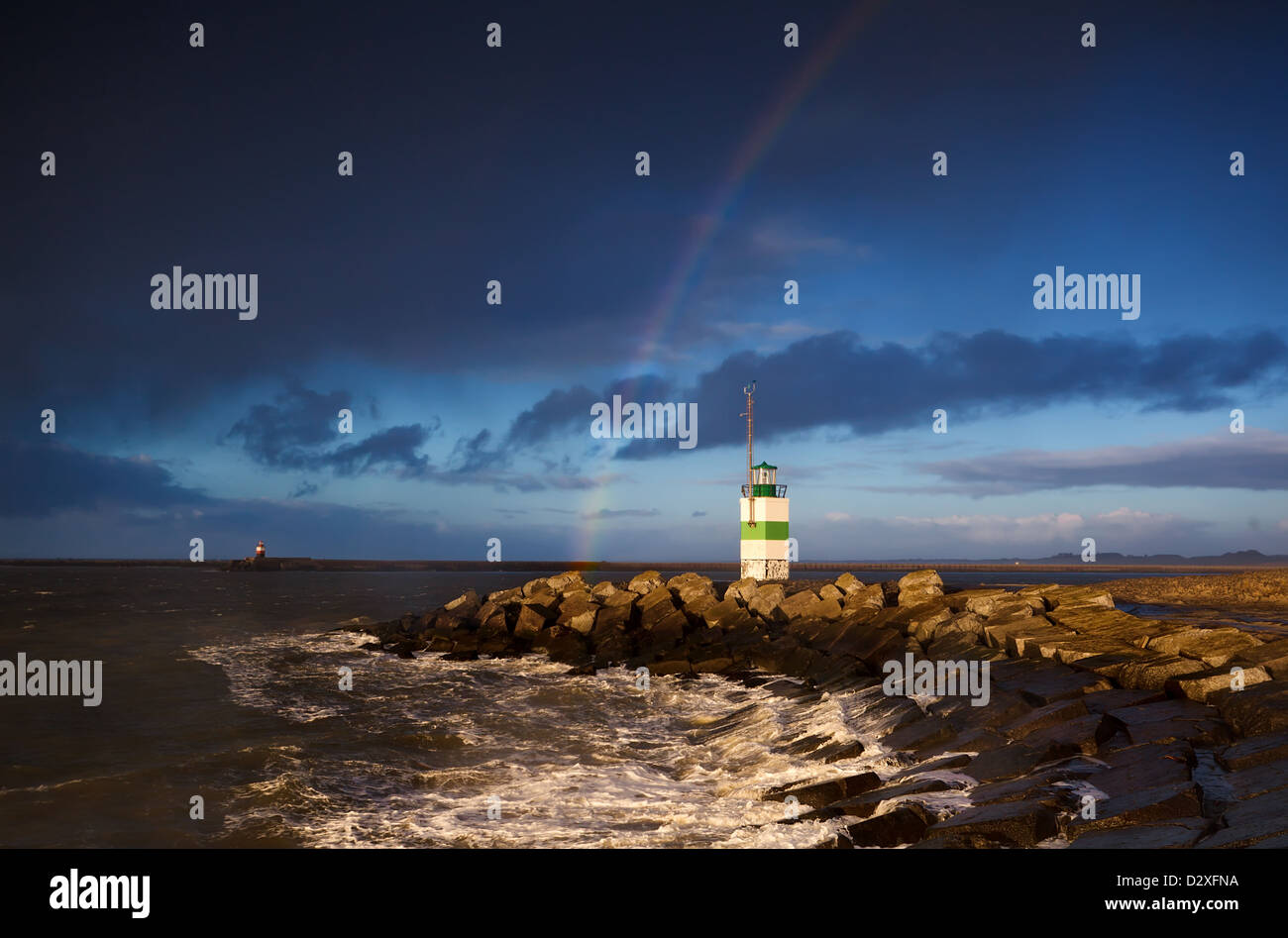 lighthouse and rainbow over North sea after shower Stock Photo