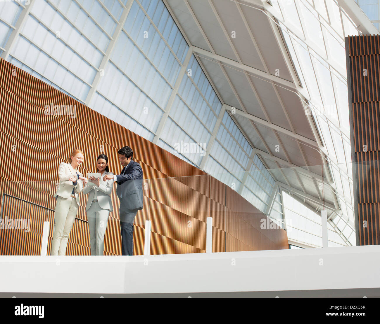 Business people using digital tablet on modern balcony in office Stock Photo