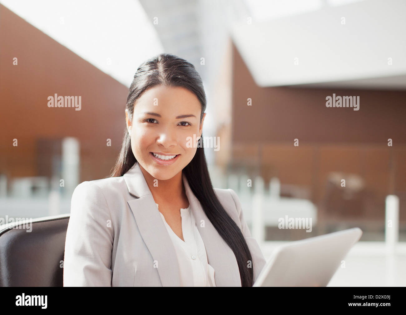 Portrait of smiling businesswoman using digital tablet in office Stock Photo