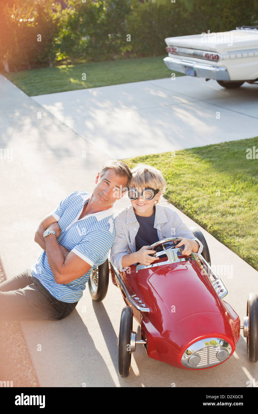 Father smiling with son in go cart Stock Photo