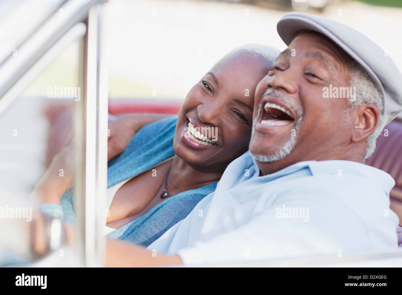 Smiling couple laughing in car Stock Photo