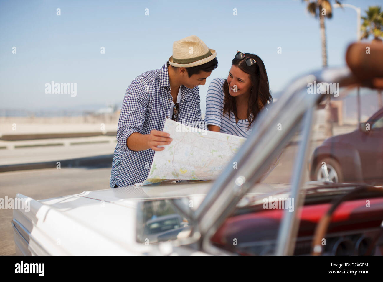 Couple reading road map on convertible Stock Photo