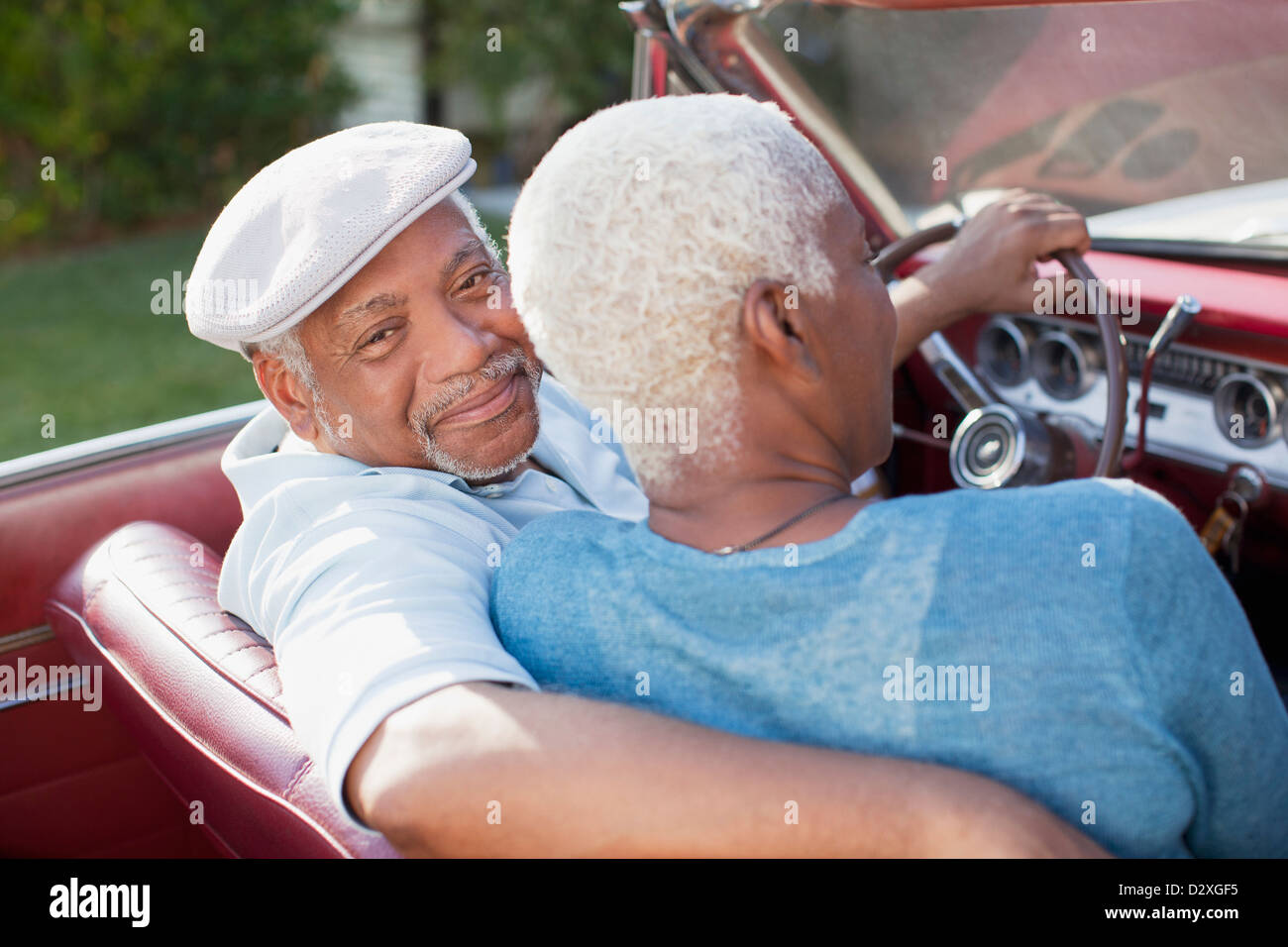 Older couple sitting in convertible Stock Photo