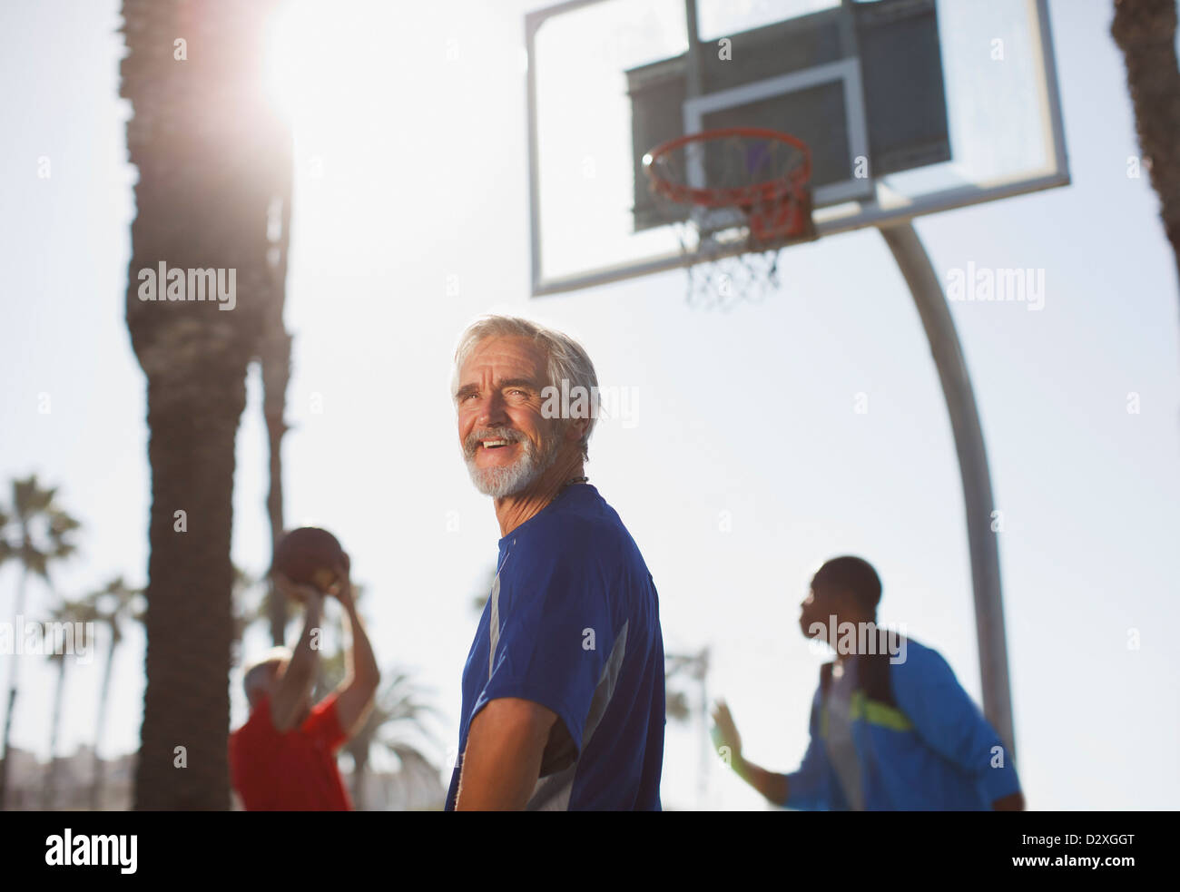 Older men playing basketball on court Stock Photo Alamy