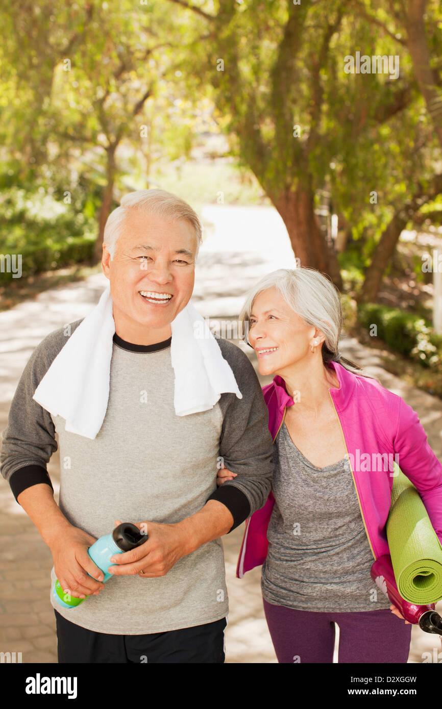 Older couple walking together outdoors Stock Photo