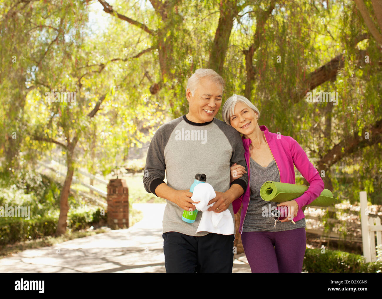 Older couple walking together outdoors Stock Photo