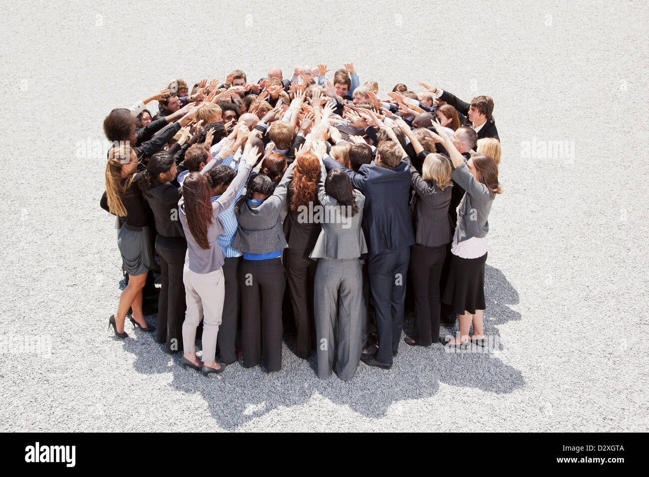 Crowd of business people in huddle Stock Photo