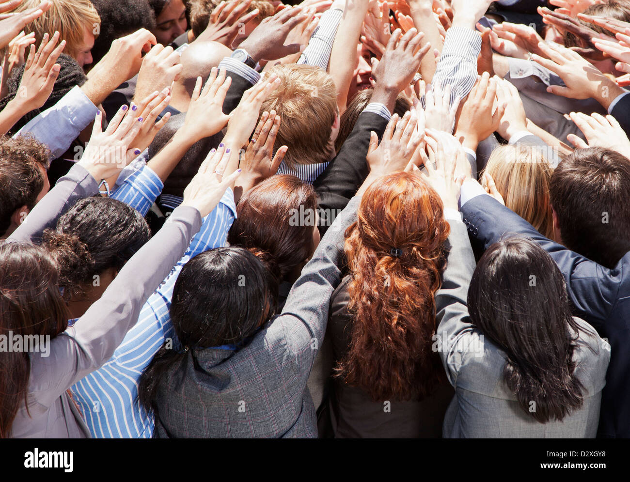 Crowd of business people reaching Stock Photo