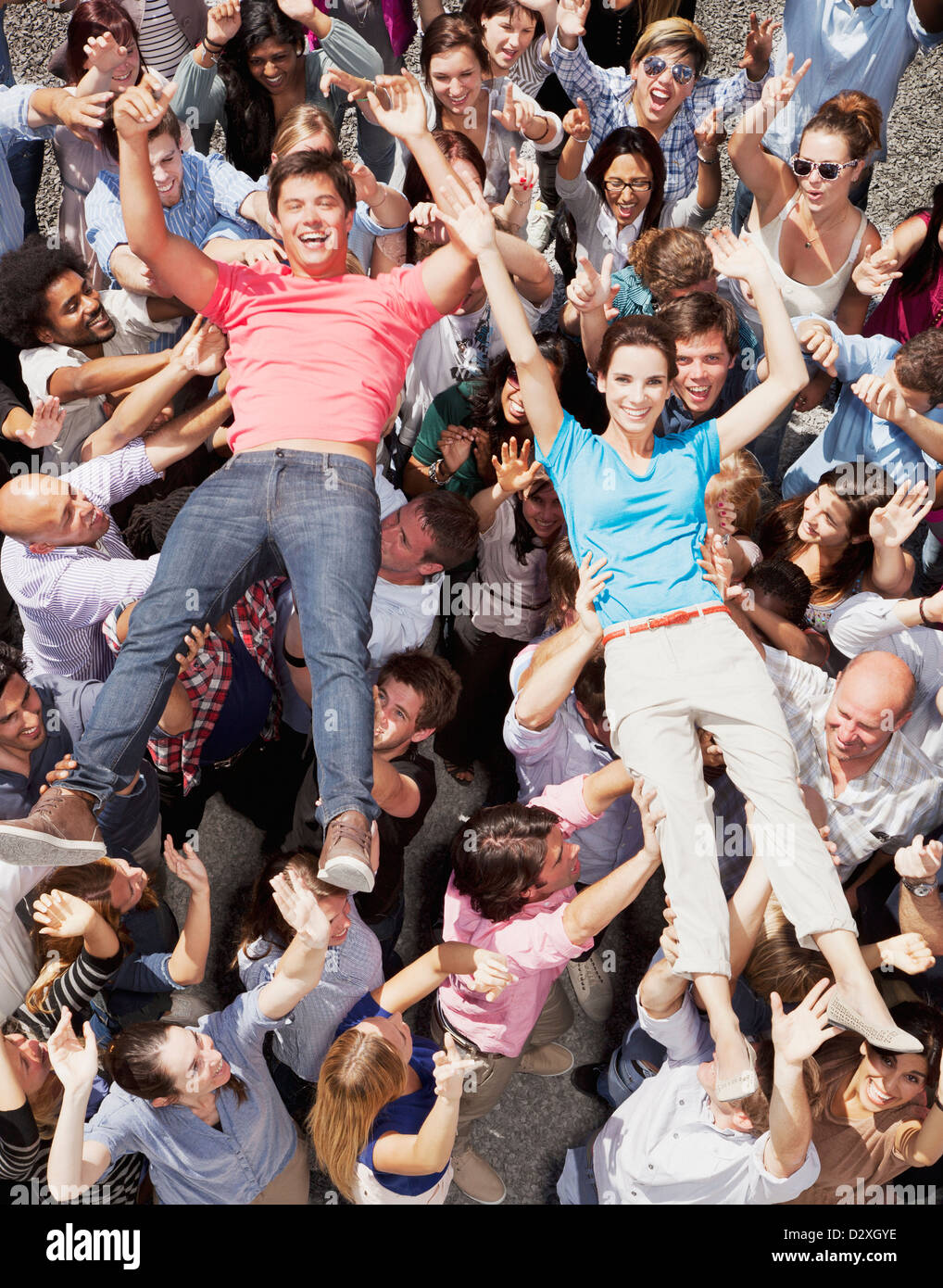 Portrait of man and woman crowd surfing Stock Photo