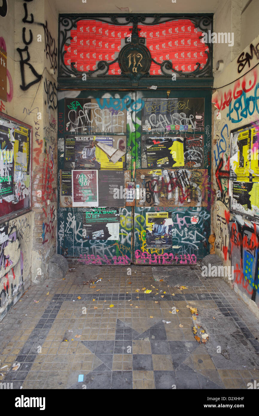 Berlin, Germany, the entrance of an old building with tags and sealed with posters Stock Photo