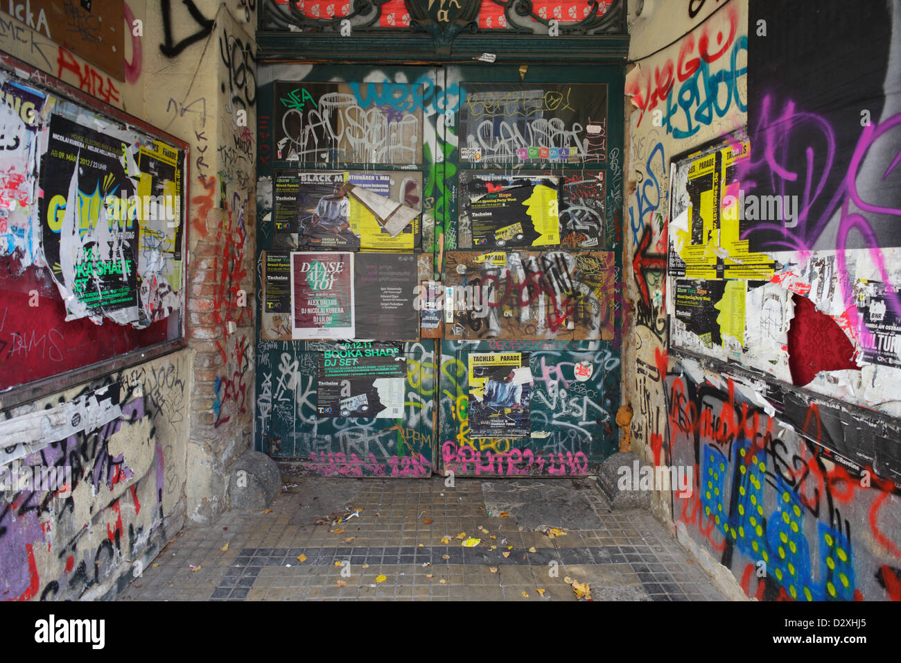 Berlin, Germany, the entrance of an old building with tags and sealed with posters Stock Photo
