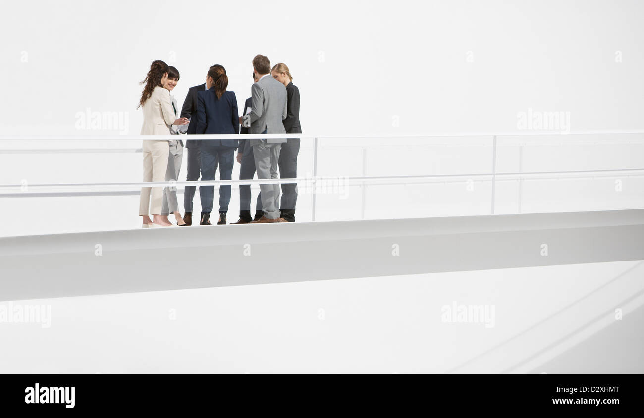 Business people meeting on elevated walkway Stock Photo