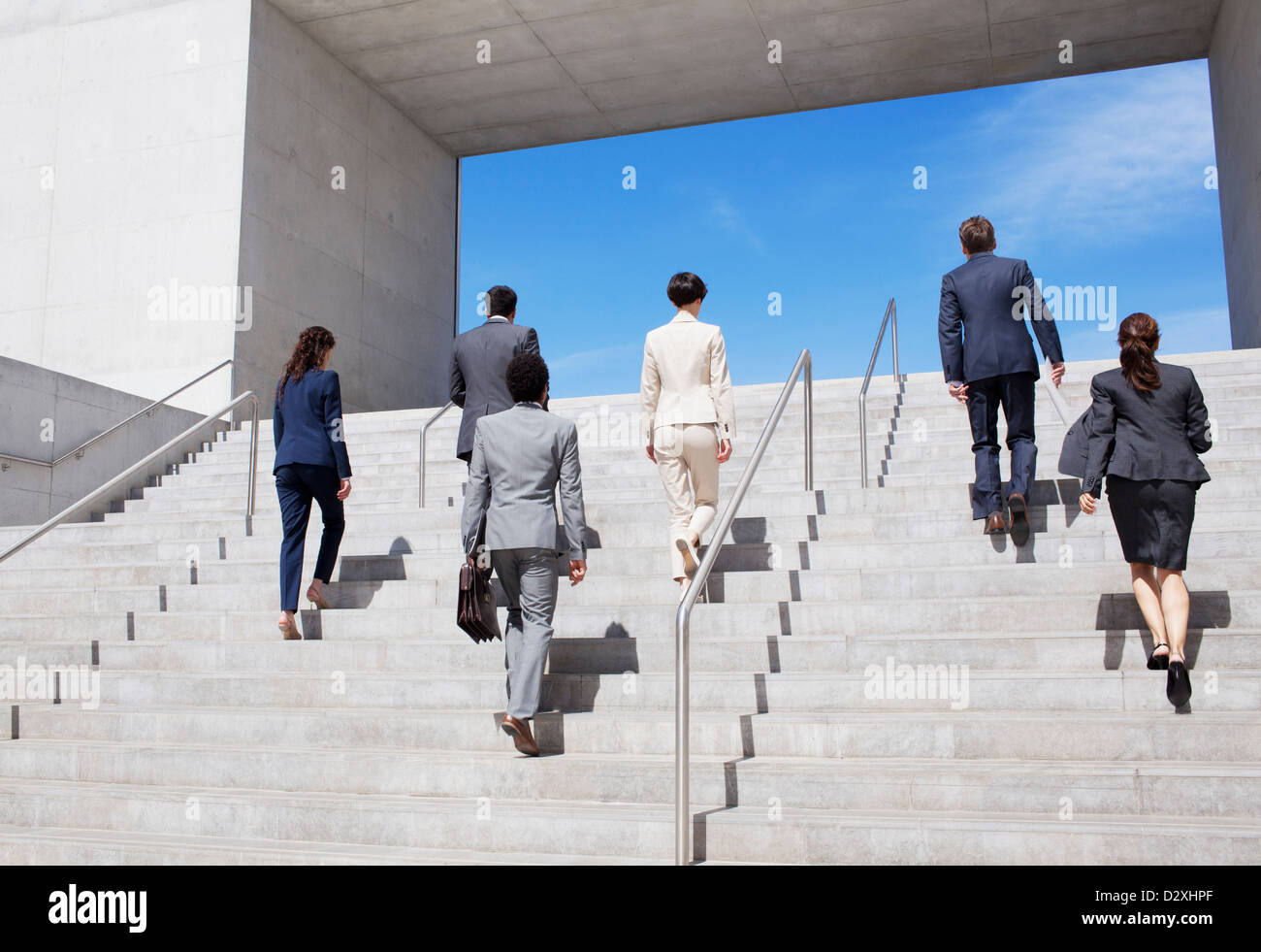Business people ascending urban stairs Stock Photo
