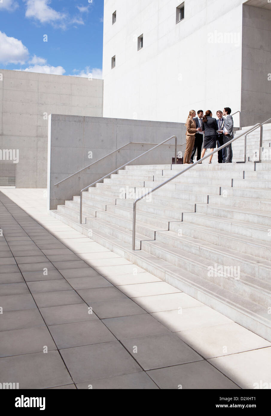 Business people meeting on urban stairs Stock Photo