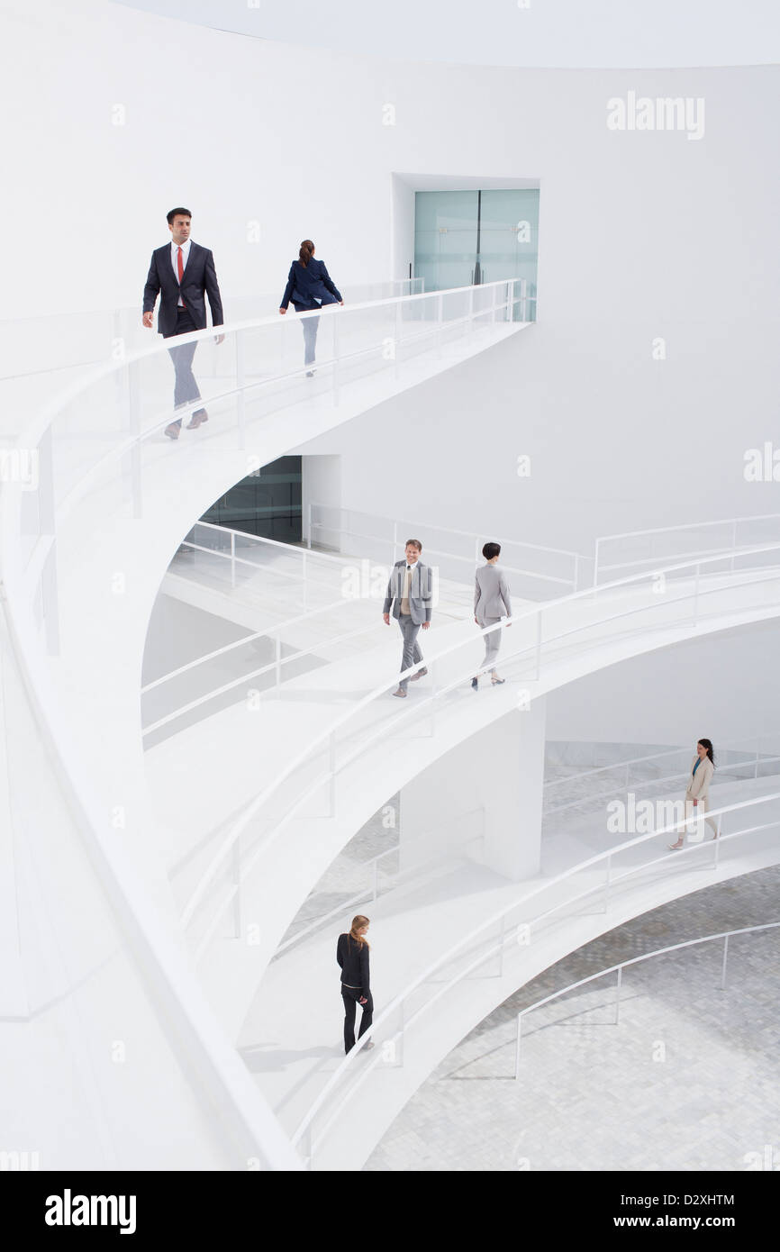 Business people walking along elevated walkways Stock Photo - Alamy