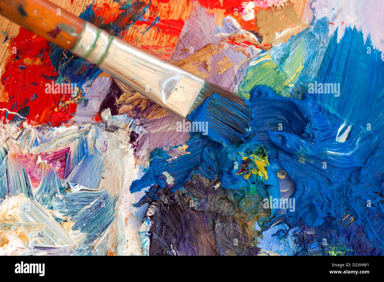 Vibrant multi-coloured artists oil paint palette. Shallow depth of