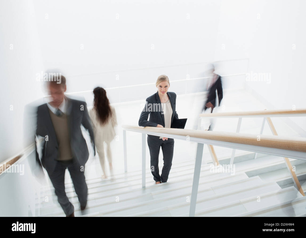 Business people rushing along stairs Stock Photo - Alamy