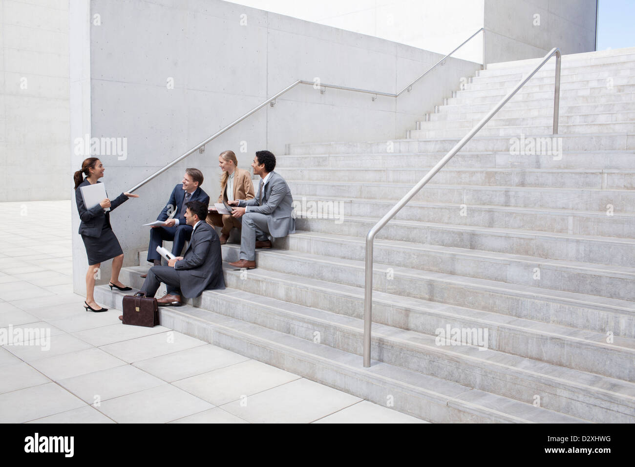 Business people meeting on urban stairs Stock Photo