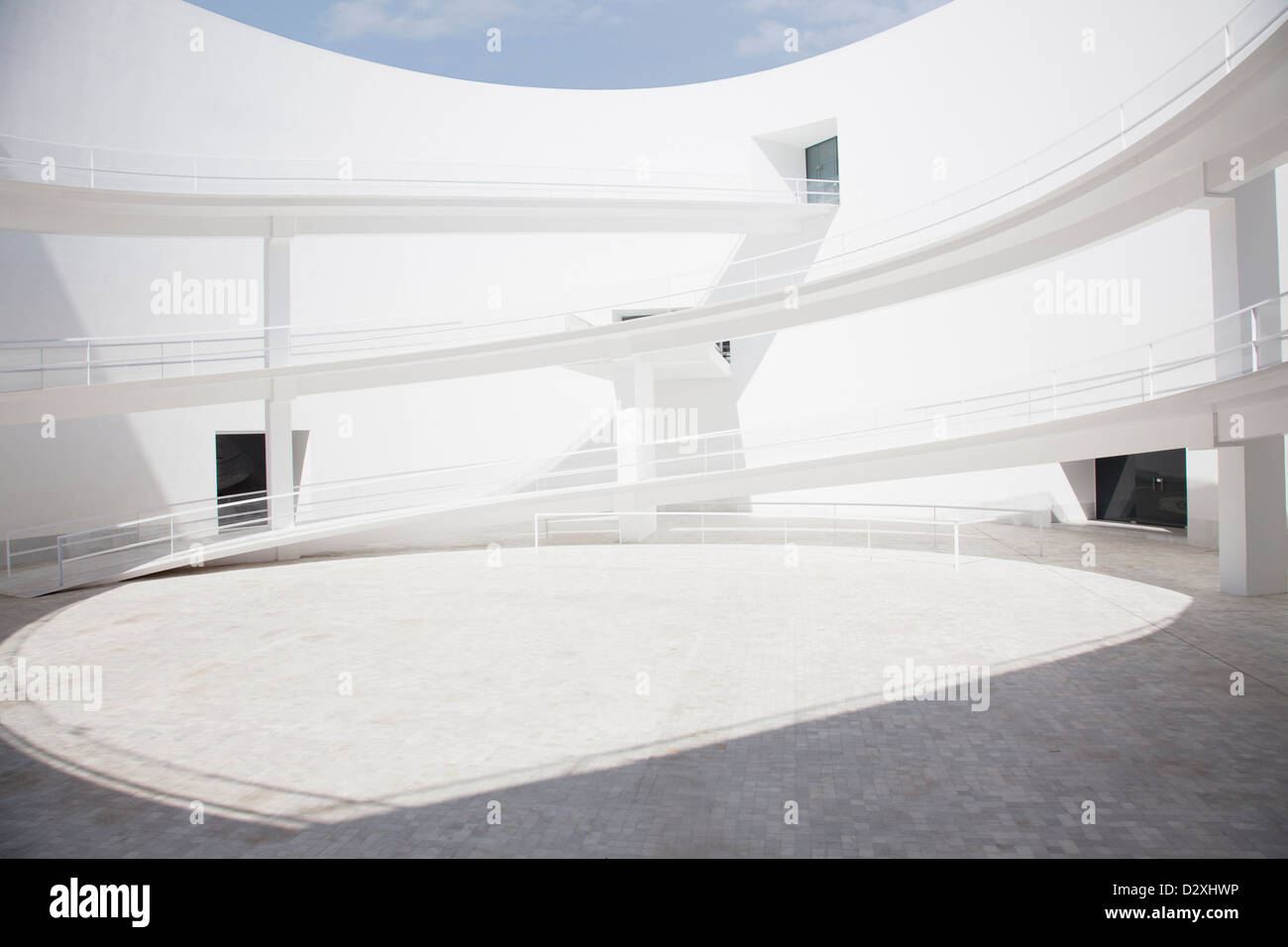 Businessman walking through modern courtyard Stock Photo