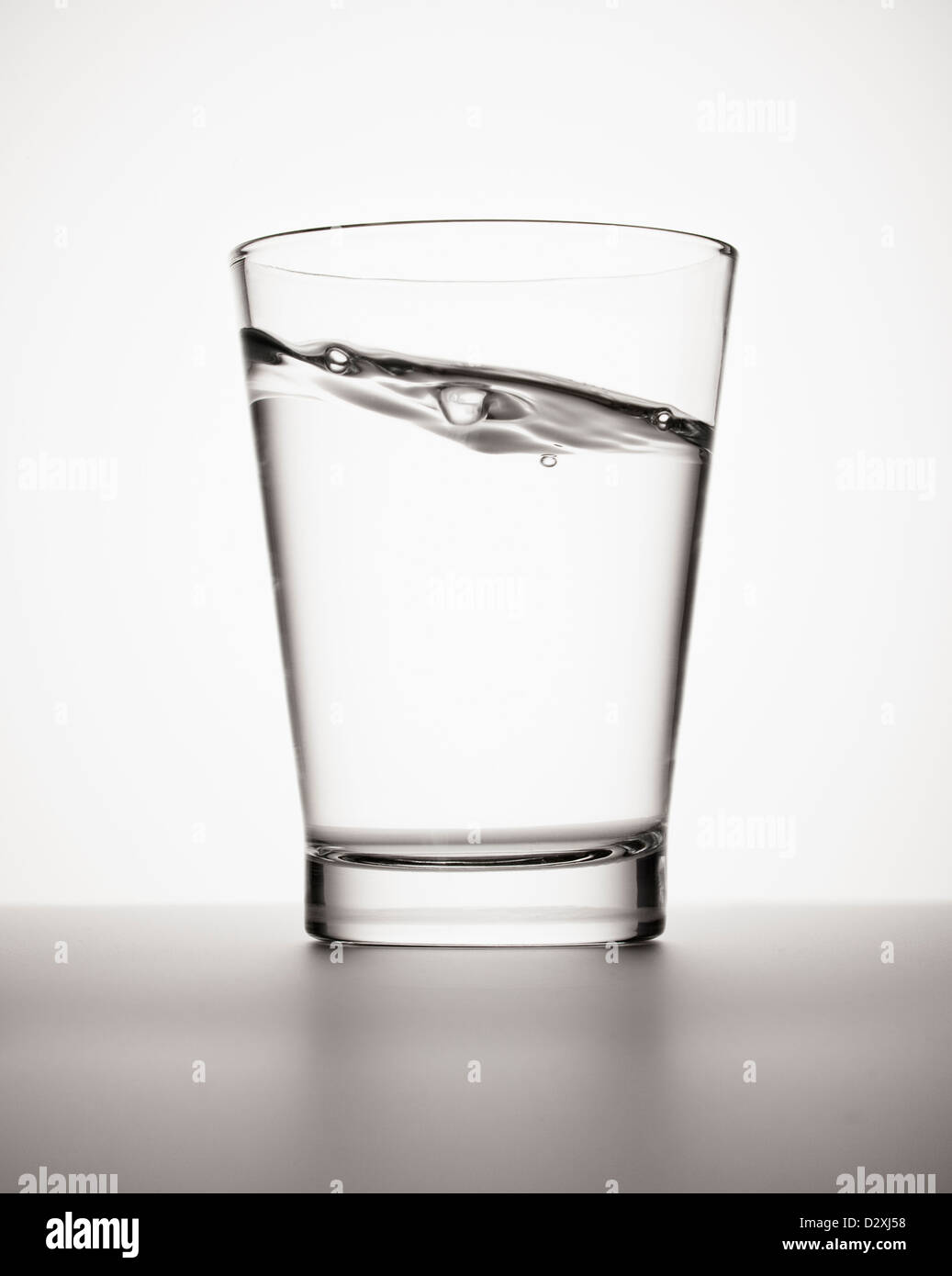 Water sloshing in glass Stock Photo
