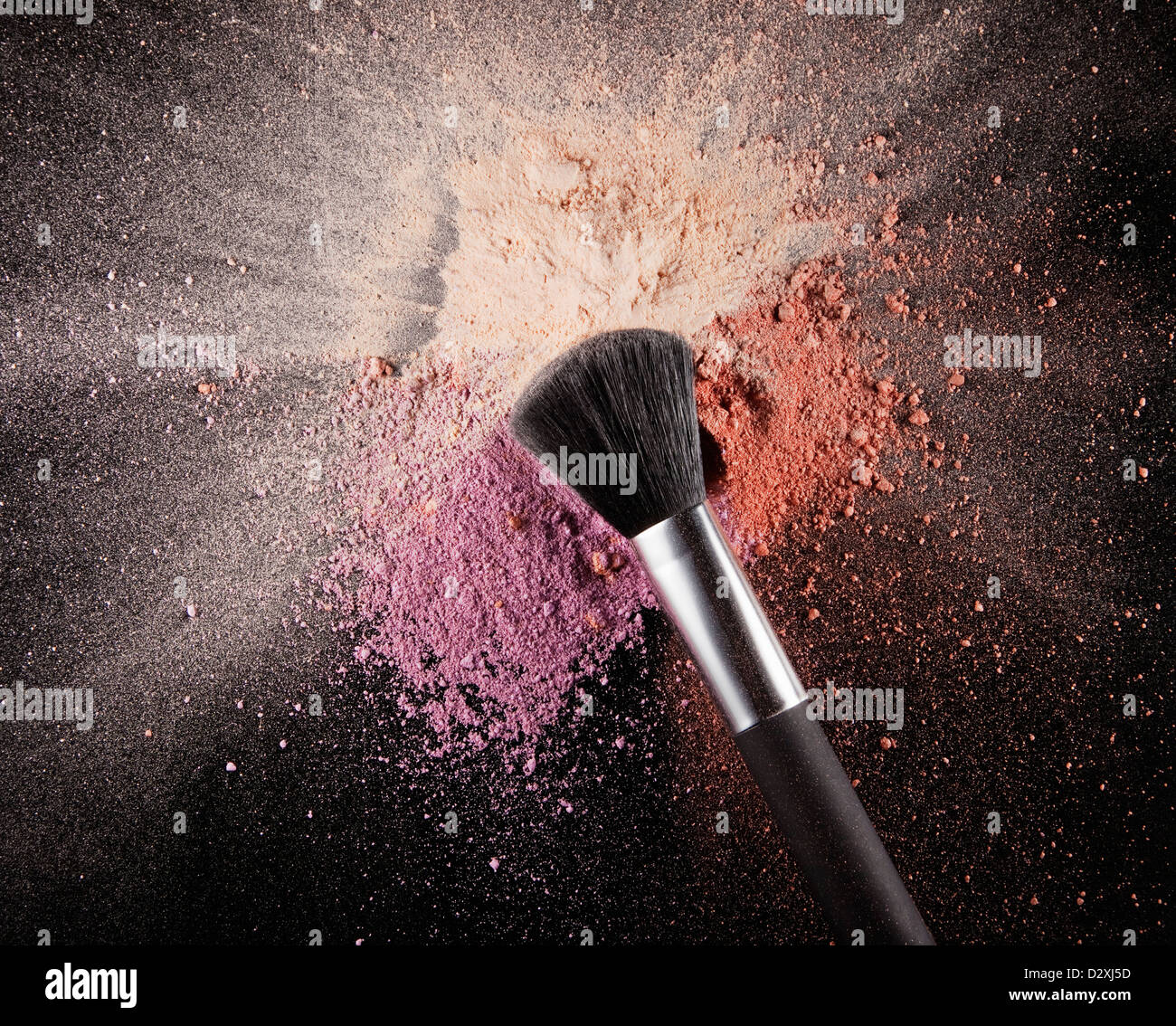 Makeup brush over multicolor blush splatter Stock Photo