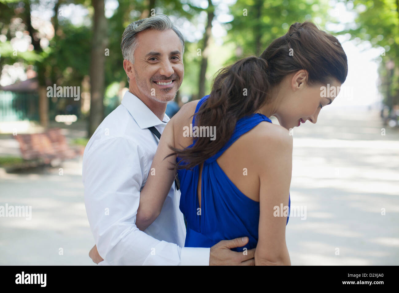 Smiling couple walking in park Stock Photo - Alamy