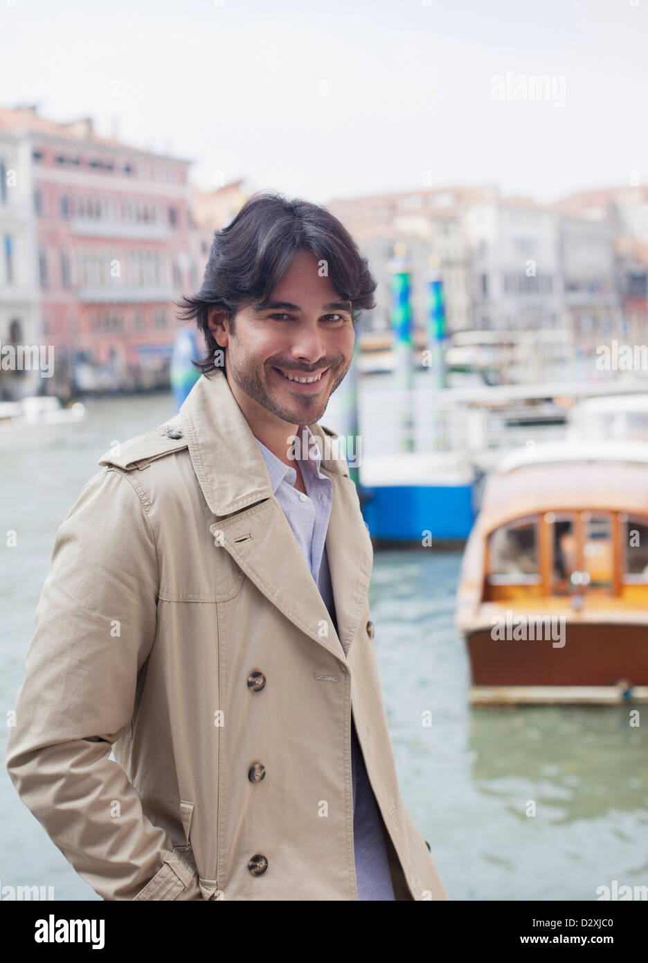 Portrait of smiling man at waterfront in Venice Stock Photo