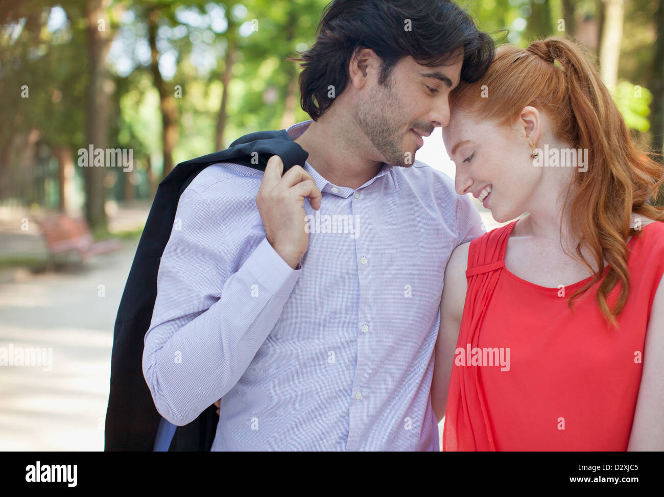 Happy couple hugging in park Stock Photo