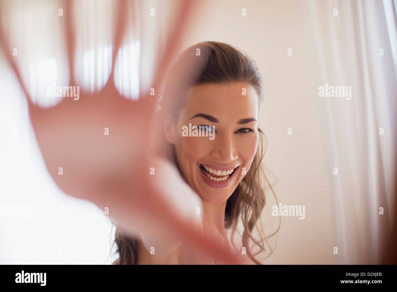 Portrait of smiling woman with hand outstretched Stock Photo