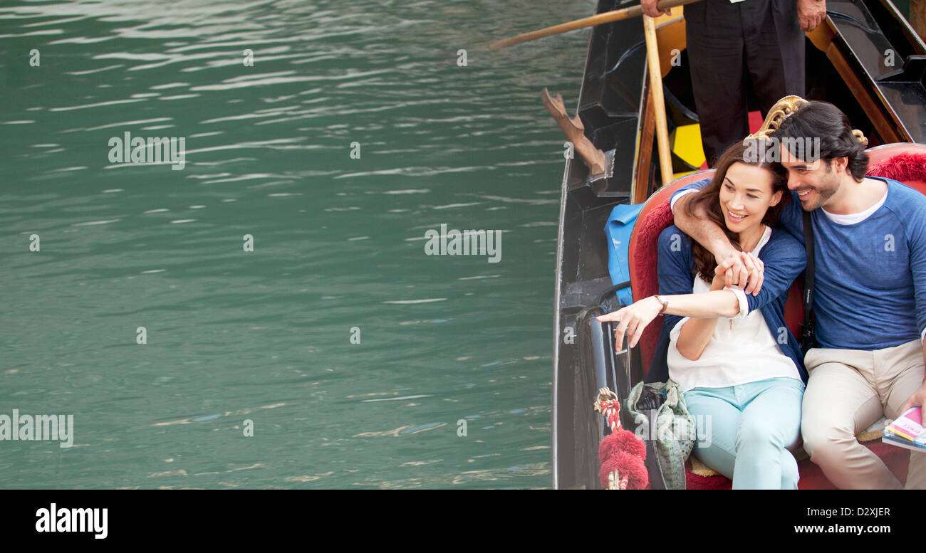 Smiling couple riding in gondola on canal in Venice Stock Photo