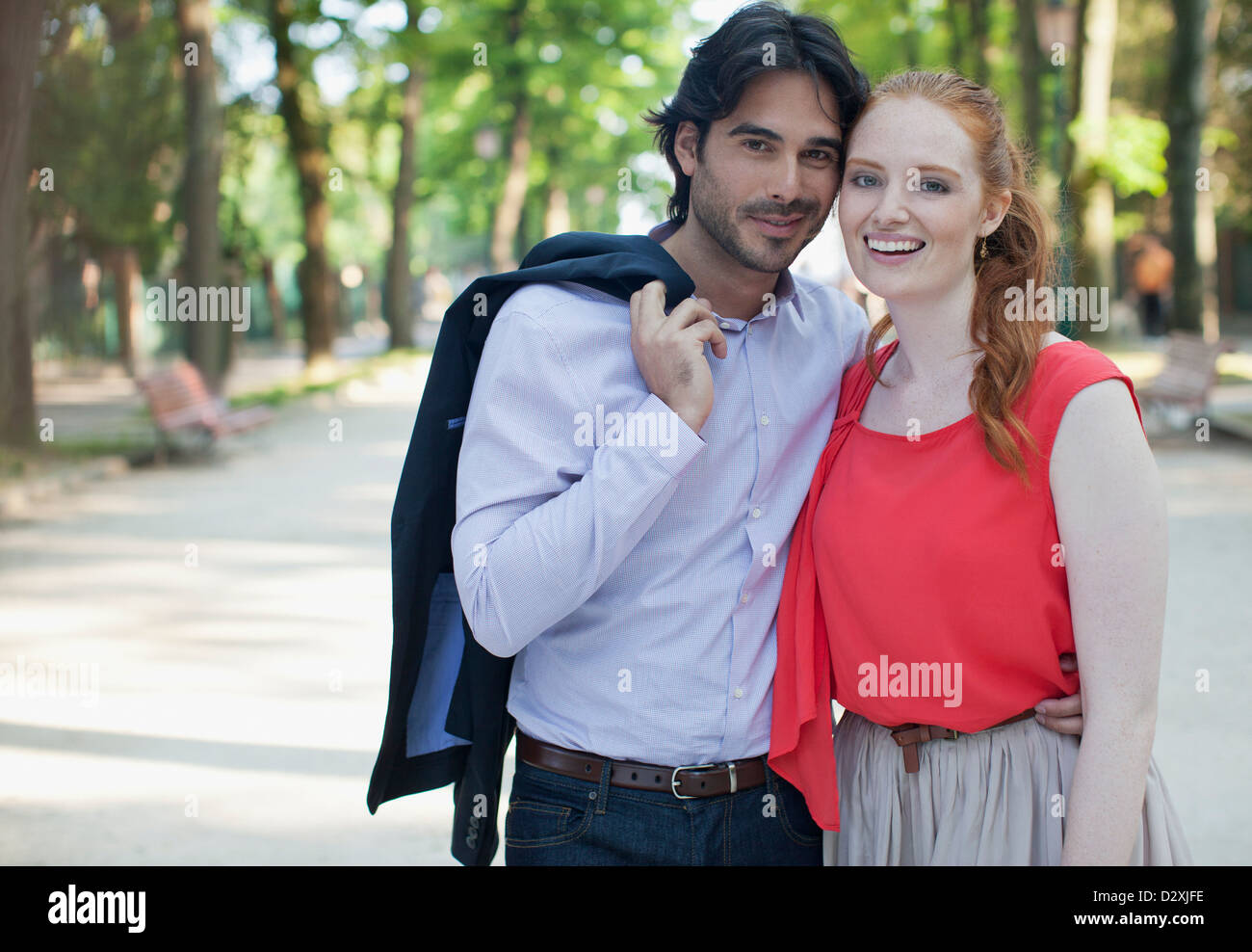 Portrait of smiling couple in park Stock Photo - Alamy