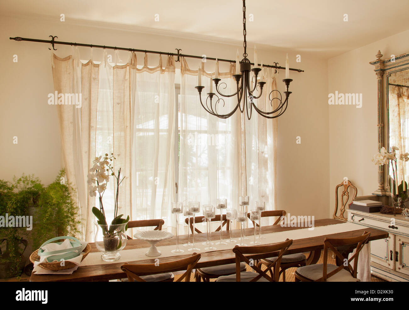 Chandelier over dining room table Stock Photo Alamy