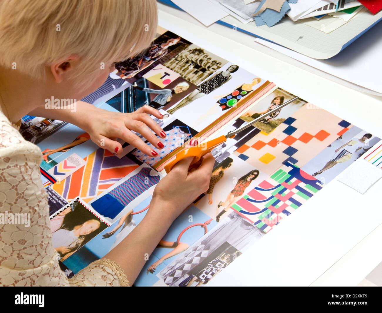 Young woman fashion designer working on mood boards for her portfolio ...