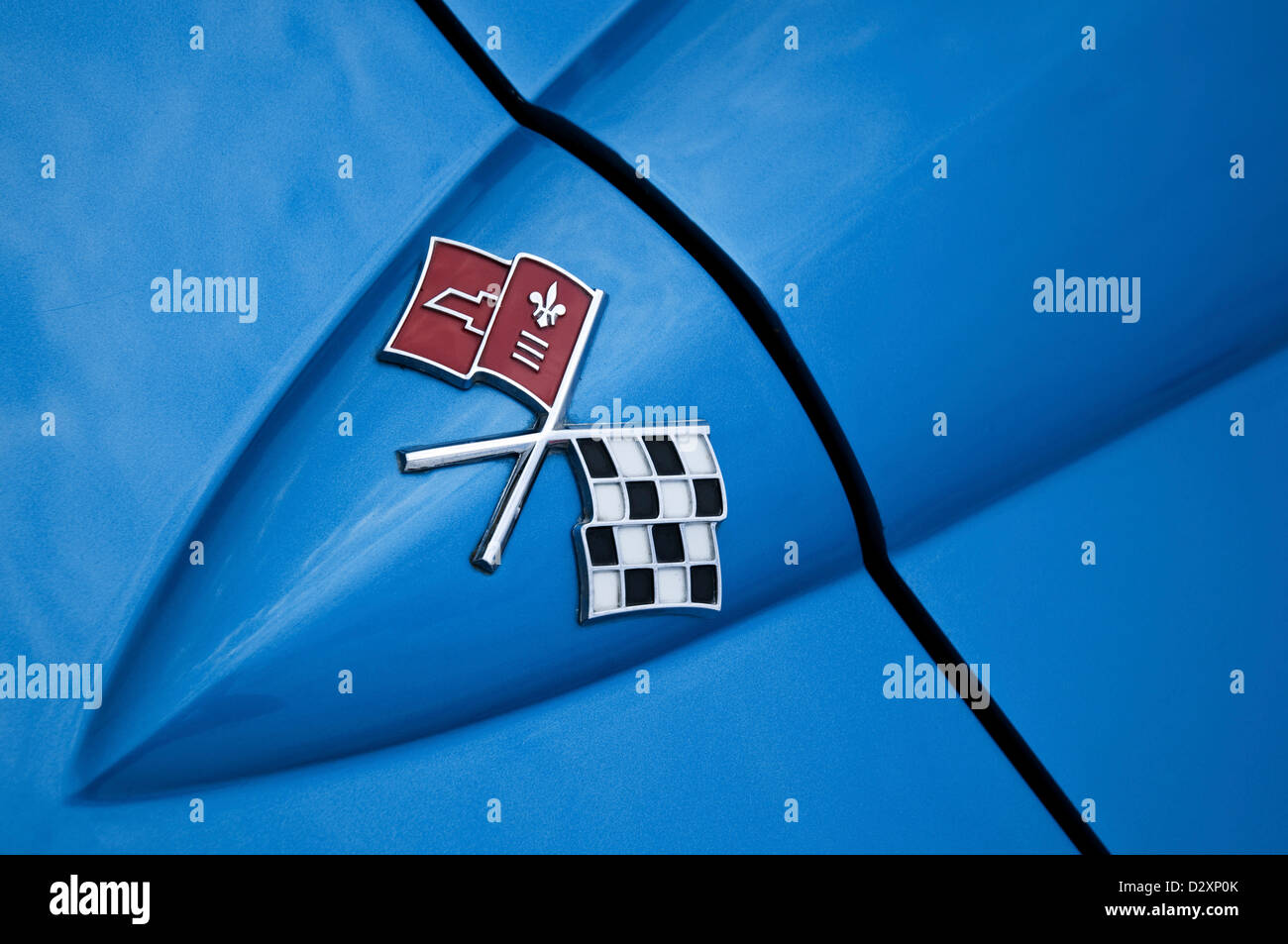 Close-up image of a badge/emblem on a blue Chevrolet Corvette Stingray car. Stock Photo