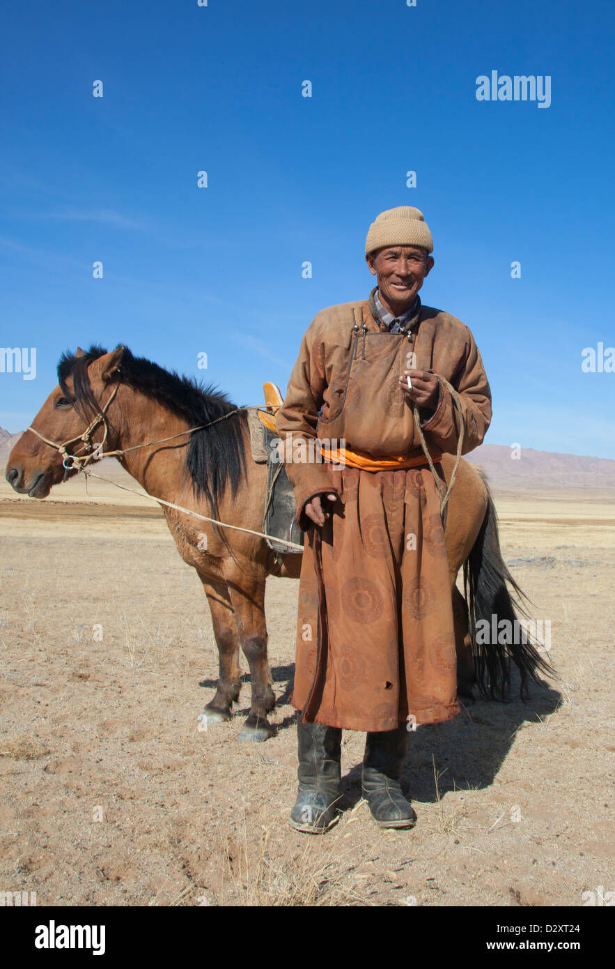 Nomad with his faithful horse in the steppes of Mongolia Stock Photo ...