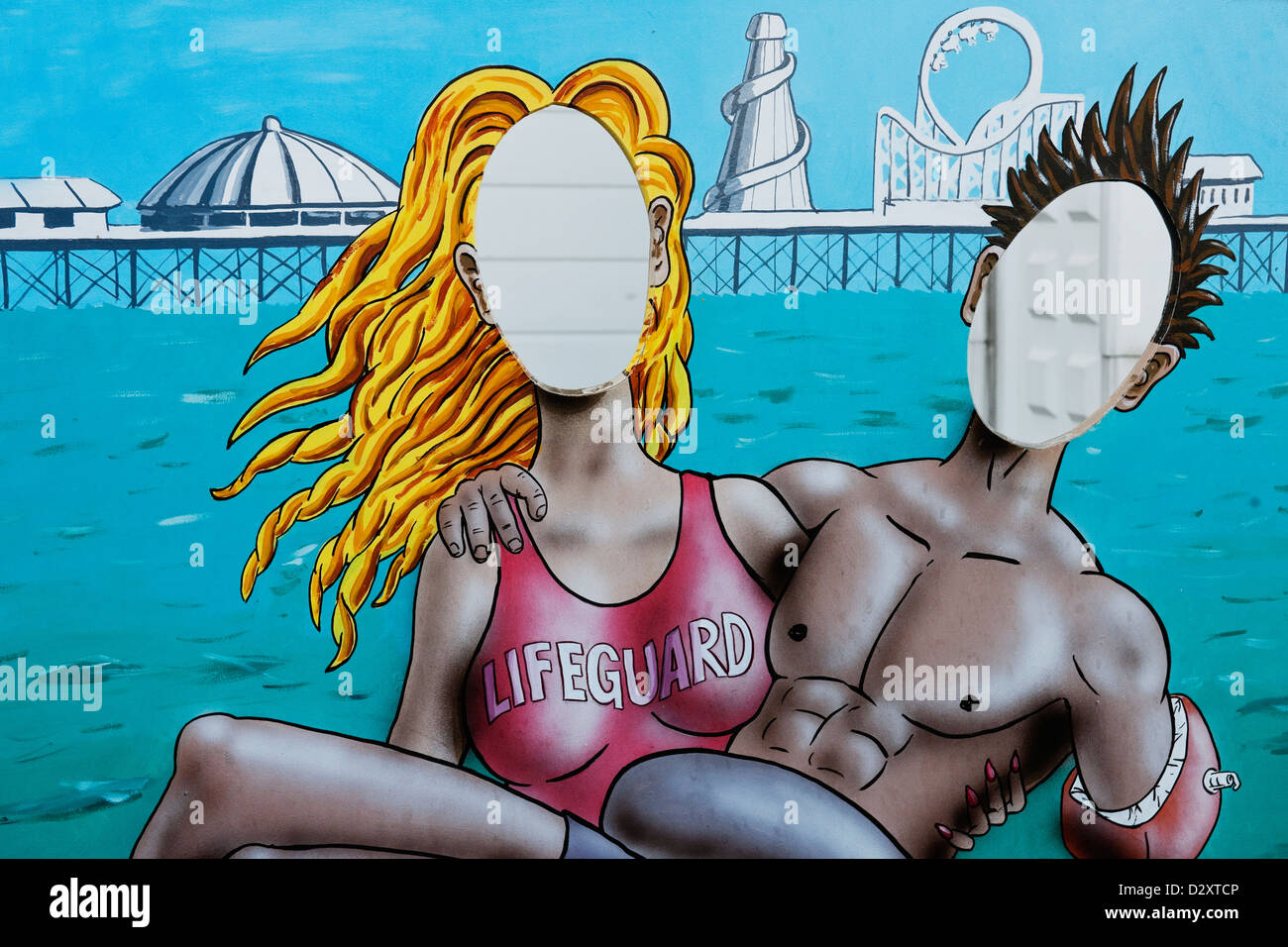 An amusing cardboard cut out showing a woman lifeguard rescuing  a  young man on  Brighton Pier East Sussex England UK Stock Photo