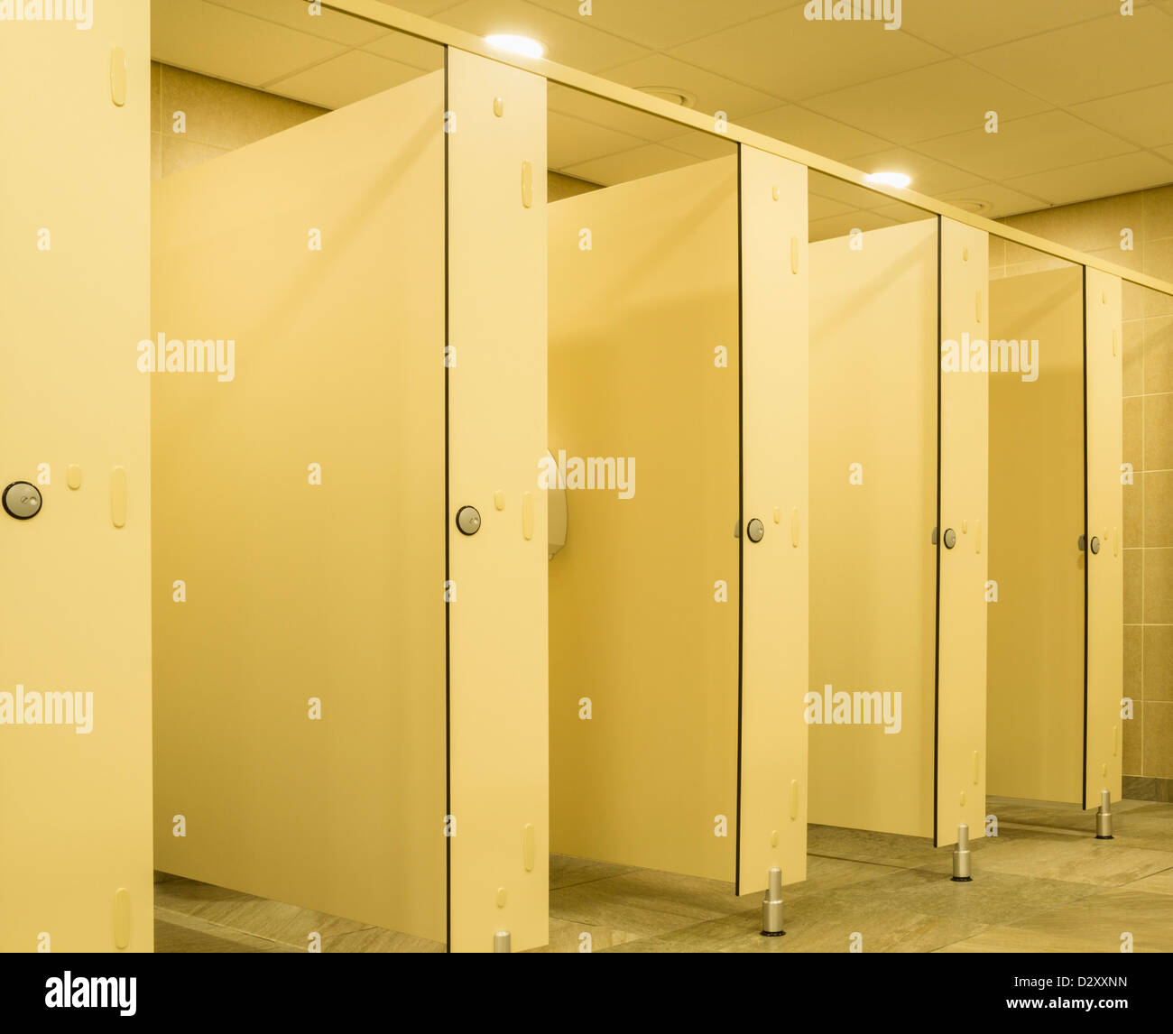 Row of cubicles in gents toilets Stock Photo