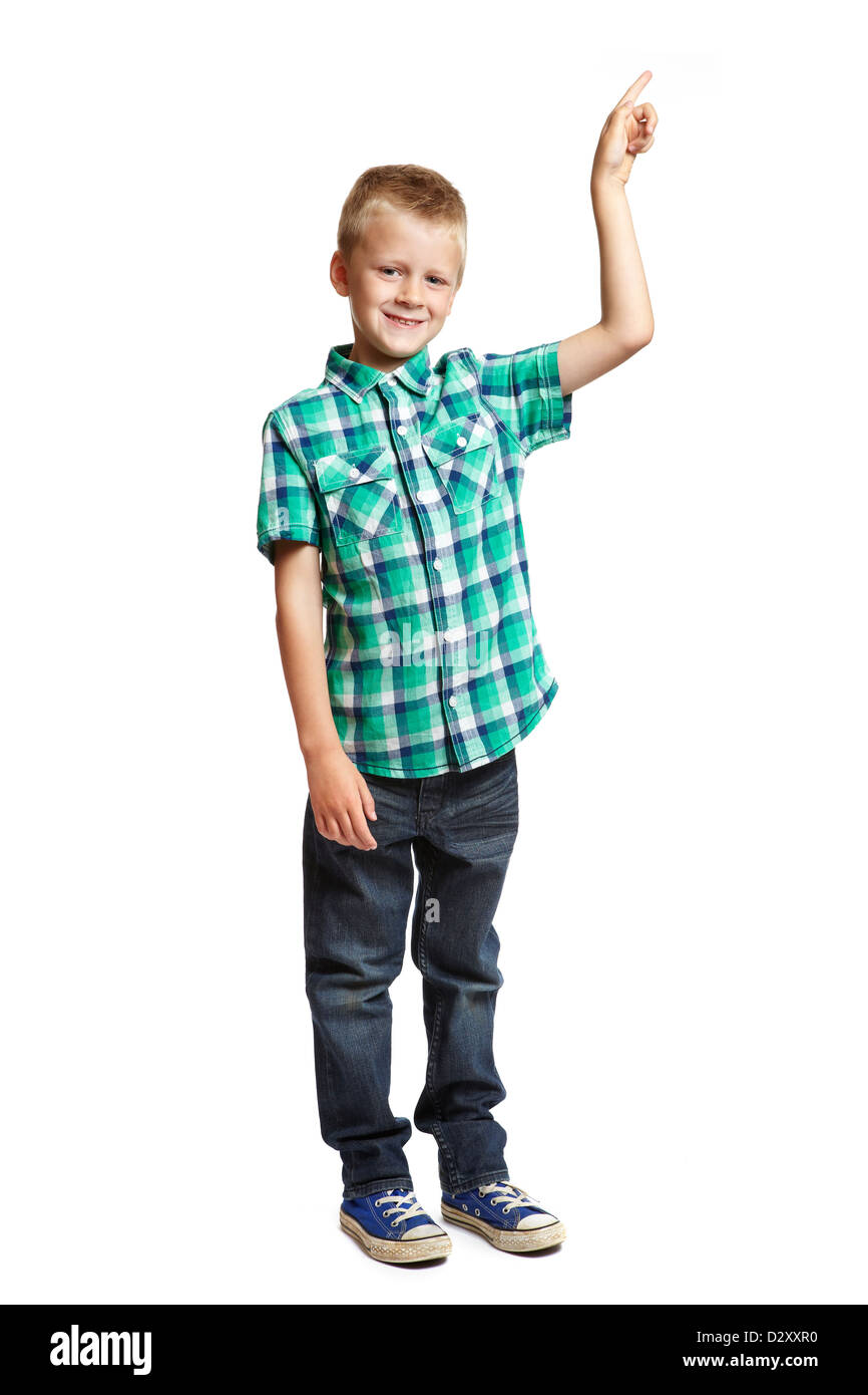 8 year old school boy pointing up on white background Stock Photo - Alamy