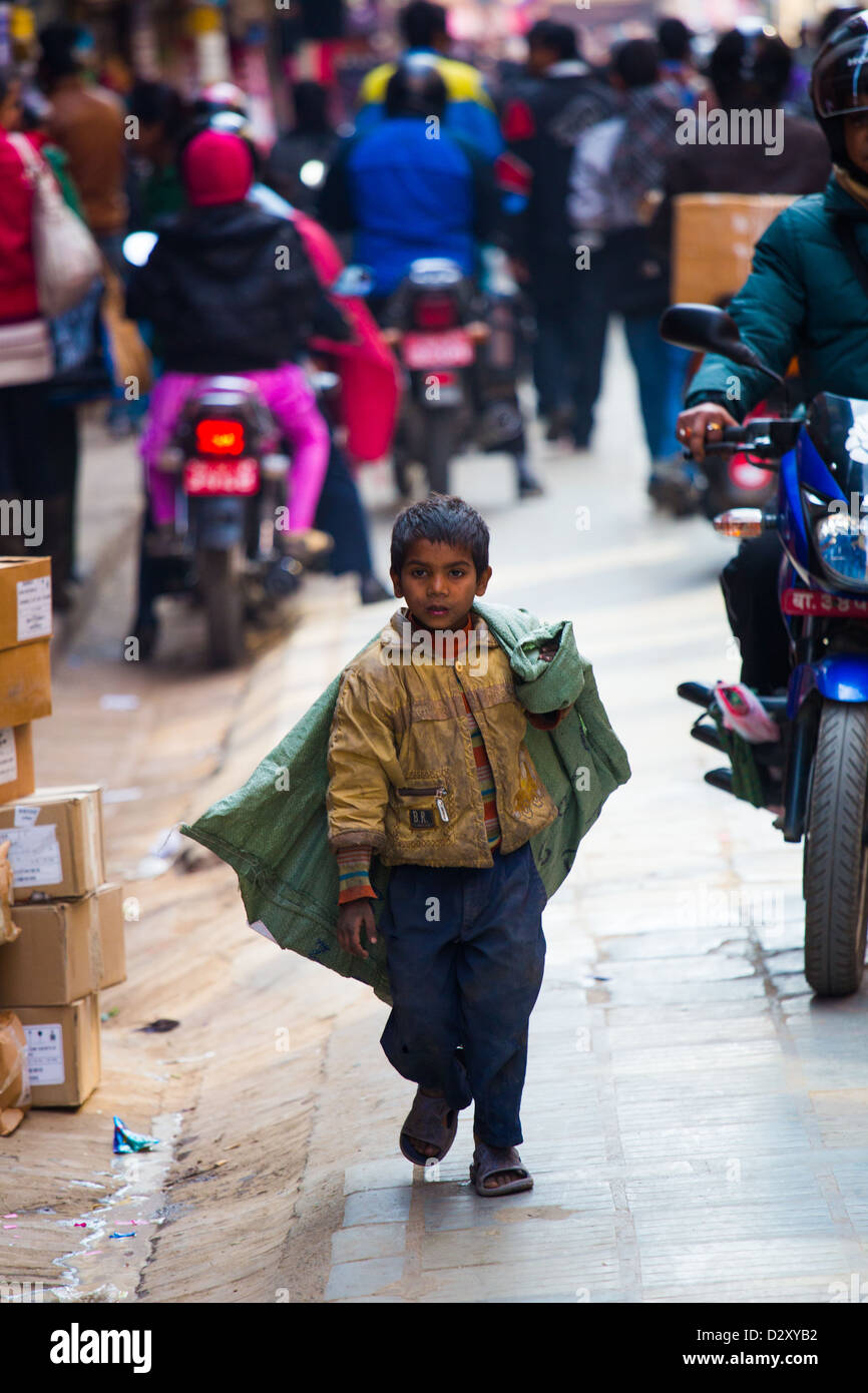 Young boy collecting recycled material in the streets of Thamel, Katmandu, Nepal Stock Photo