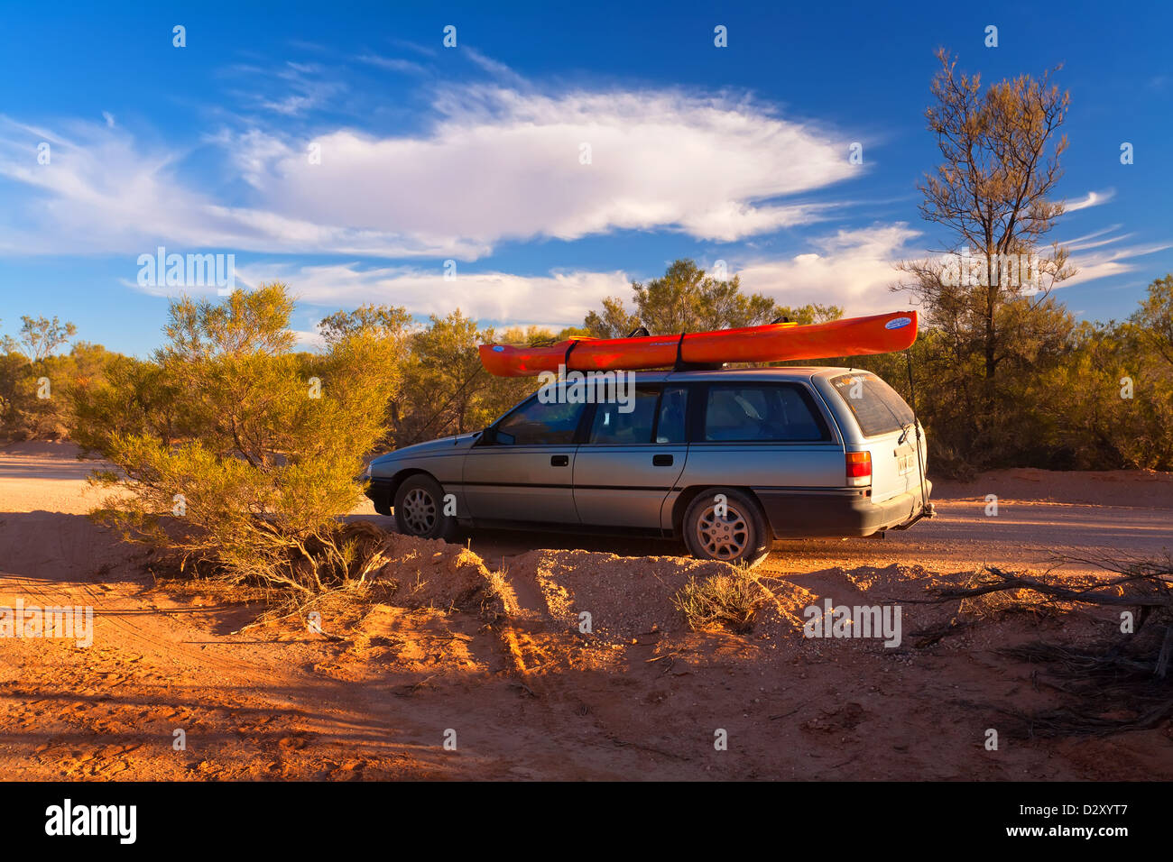 Car with a canoe on the roof racks Stock Photo